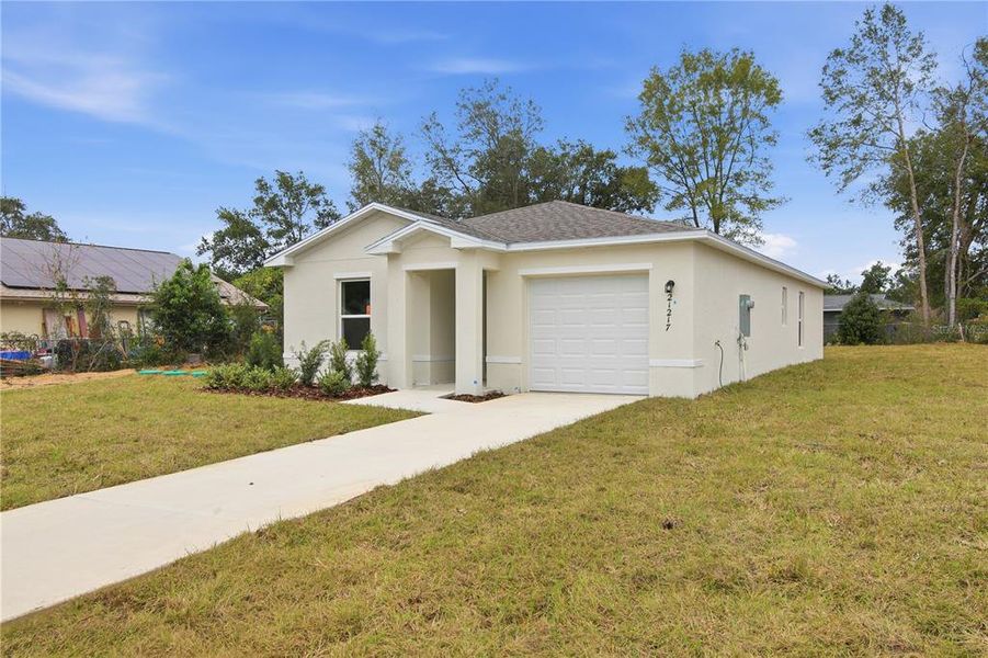 Front exterior of a new home in Rainbow Lakes Estates, Dunnellon, FL, highlighting curb appeal (Image 19). Front exterior of a new home in Rainbow Lakes Estates, Dunnellon, FL, highlighting curb appeal (Image 19).