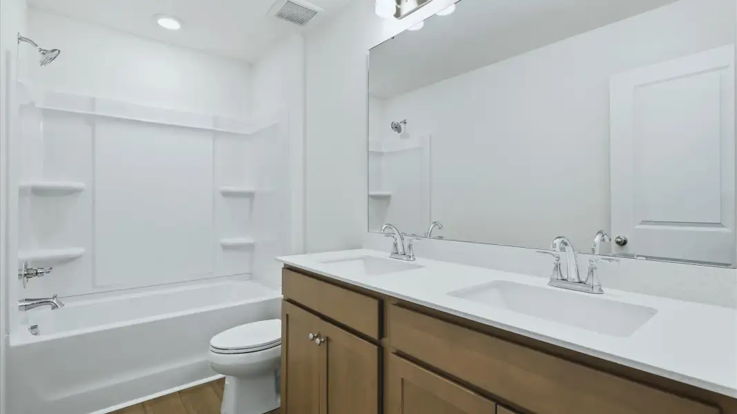 The Pritchard’s secondary bath features a dual vanity and tub