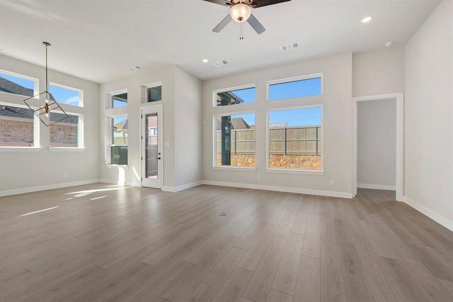 Unfurnished living room featuring a ceiling fan, recessed lighting, and light wood-style flooring