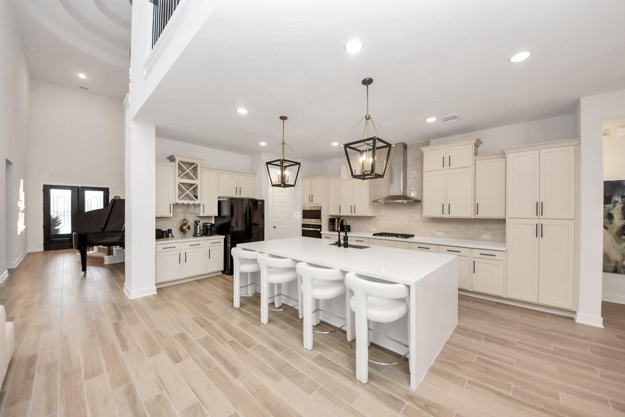 Open-concept kitchen flowing seamlessly from the foyer with a spacious island and modern finishes.