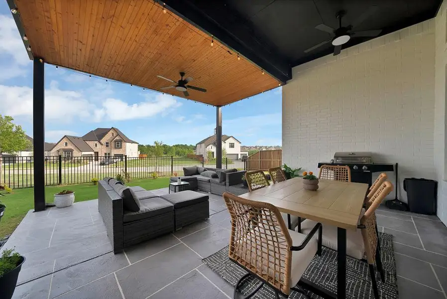 Covered outdoor patio featuring a wood-finish ceiling with string lighting Covered outdoor patio featuring a wood-finish ceiling with string lighting