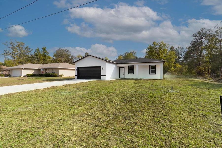 Front exterior of a new home in , Ocklawaha, FL, highlighting curb appeal (Image 21).