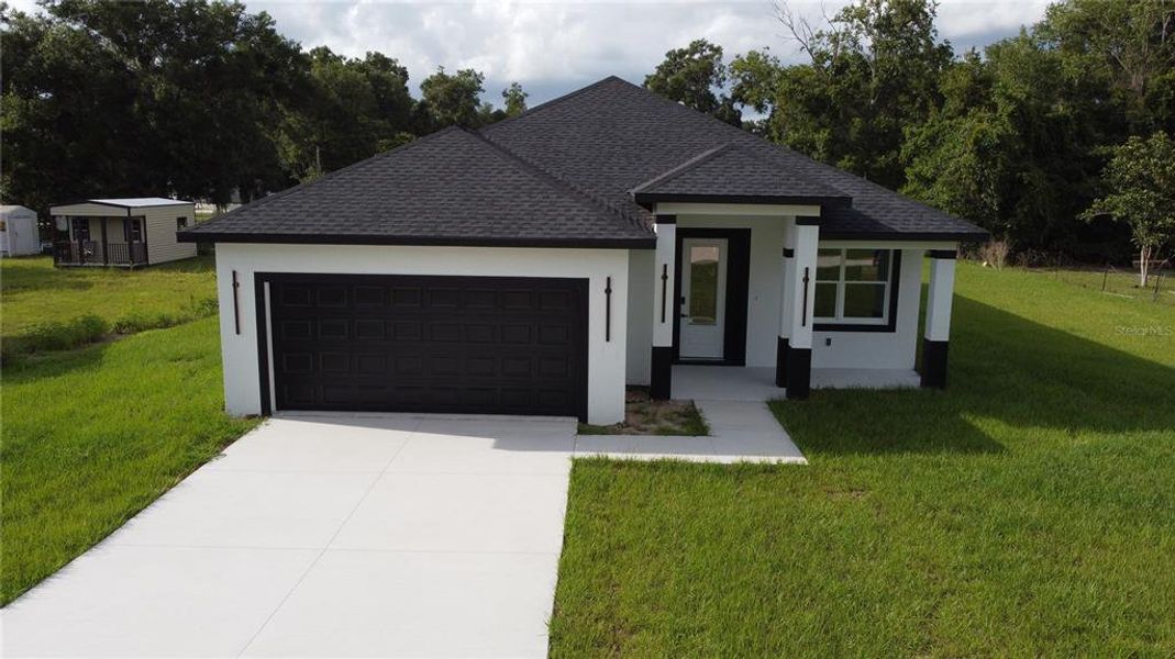 Front exterior of a new home in , Summerfield, FL, highlighting curb appeal (Image 26).