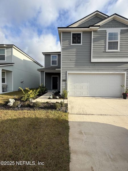 Front exterior of a new home in The Arbors, Jacksonville, FL, highlighting curb appeal (Image 10).