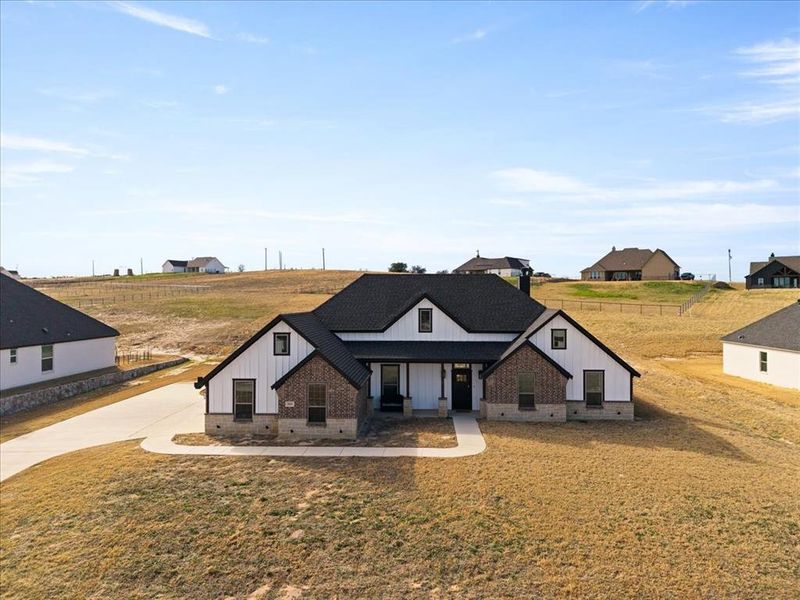 Front exterior of a new home in , Springtown, TX, highlighting curb appeal (Image 26).