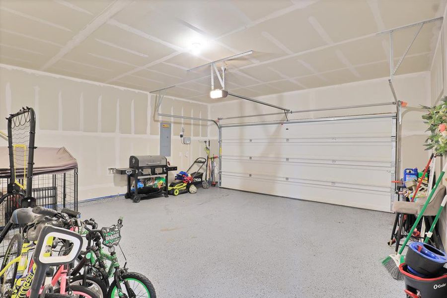 Garage with electric panel and a garage door opener