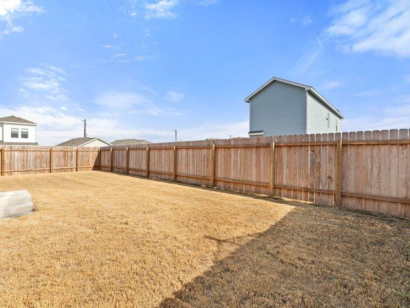 View of fenced backyard