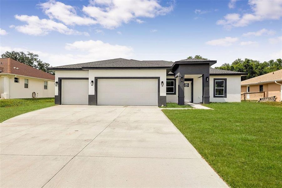 Front exterior of a new home in , North Port, FL, highlighting curb appeal (Image 23). Front exterior of a new home in , North Port, FL, highlighting curb appeal (Image 23).