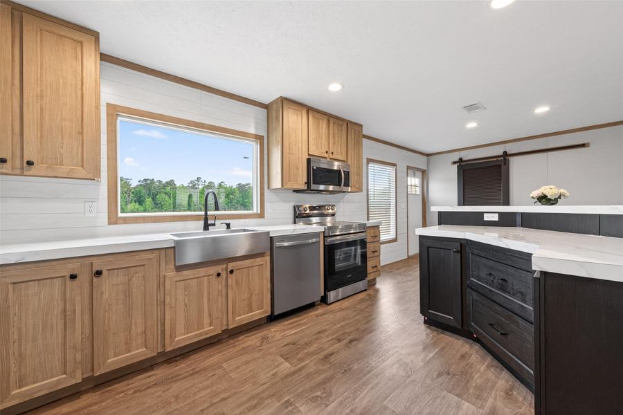 Stunning open-concept kitchen featuring modern finishes, stainless steel appliances, and a spacious center island that seamlessly connects to the living and dining areas, ideal for entertaining. Stunning open-concept kitchen featuring modern finishes, stainless steel appliances, and a spacious center island that seamlessly connects to the living and dining areas, ideal for entertaining.