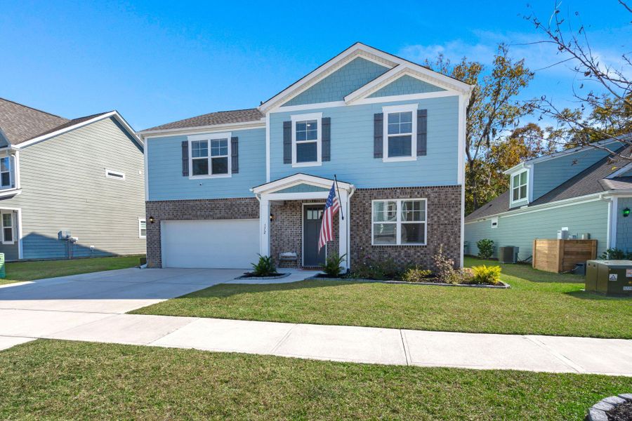 Front exterior of a new home in The Ponds, Summerville, SC, highlighting curb appeal (Image 22). Front exterior of a new home in The Ponds, Summerville, SC, highlighting curb appeal (Image 22).
