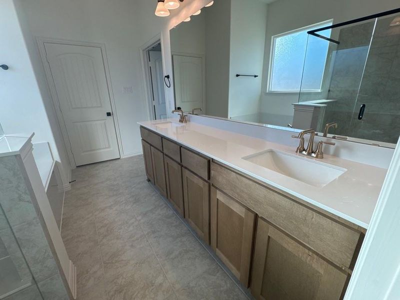 Full bathroom with a garden tub, double vanity, and a stall shower Full bathroom with a garden tub, double vanity, and a stall shower