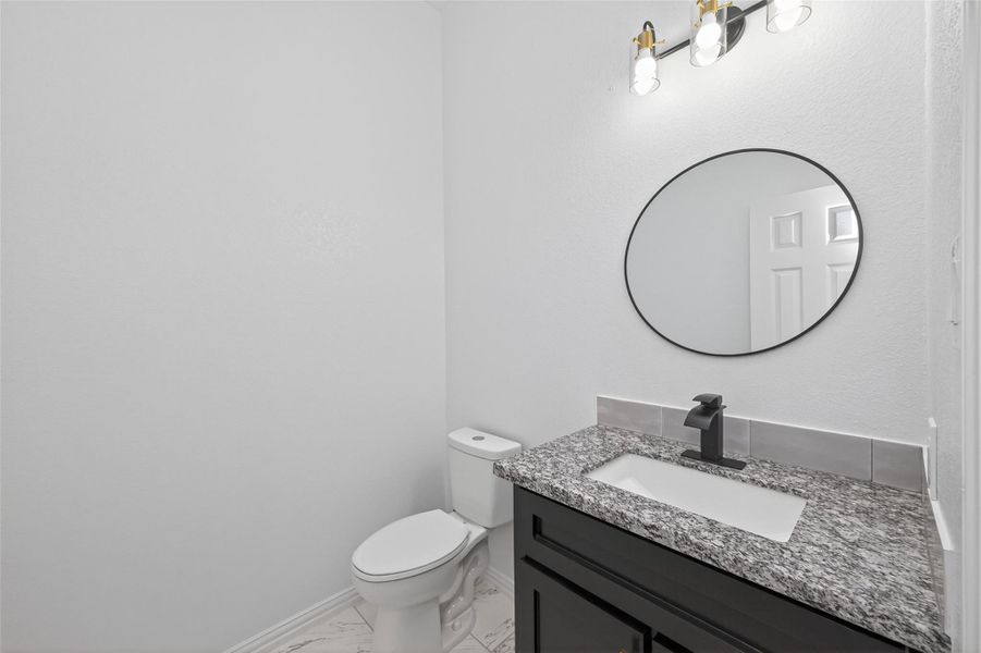 Beautiful secondary bathroom showcasing custom cabinetry and modern design details.