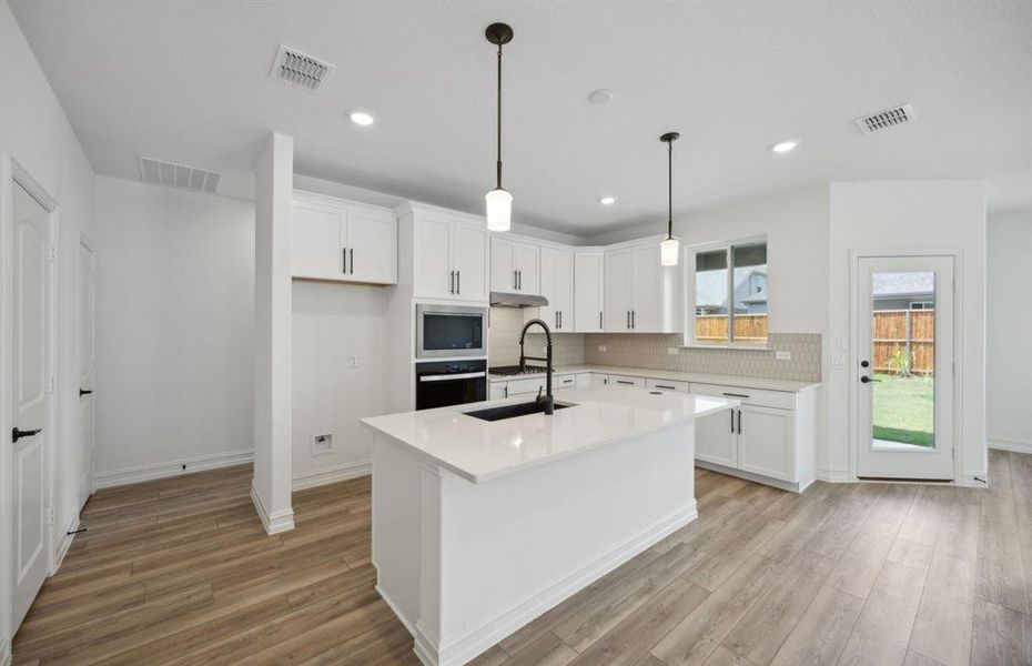 Bright kitchen with ample cabinet space *real home pictured