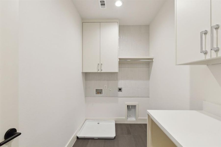 Laundry area featuring cabinets, hookup for an electric dryer, and washer hookup