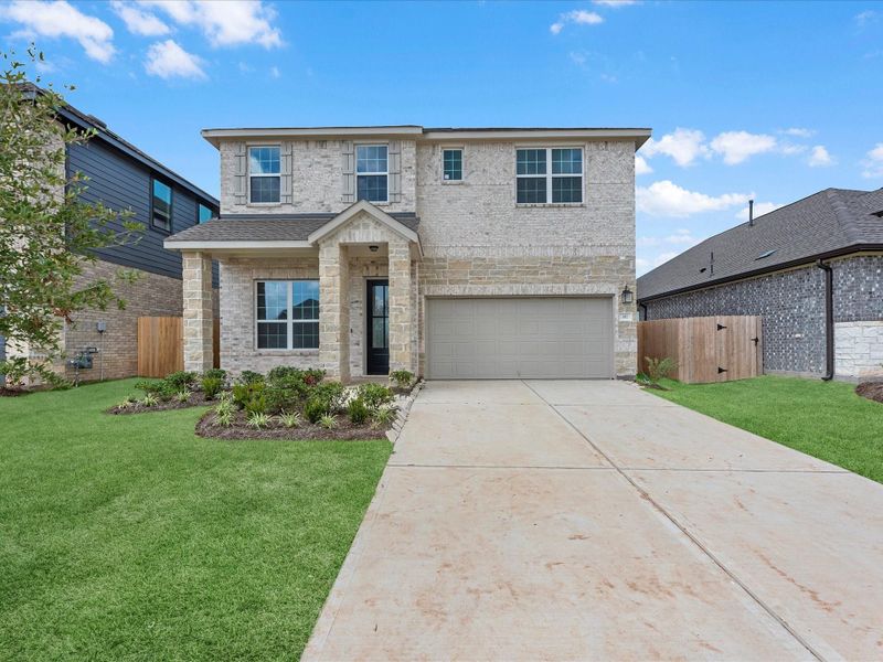 Front exterior of a new home in Azalea, Brookshire, TX, highlighting curb appeal (Image 2). Front exterior of a new home in Azalea, Brookshire, TX, highlighting curb appeal (Image 2).