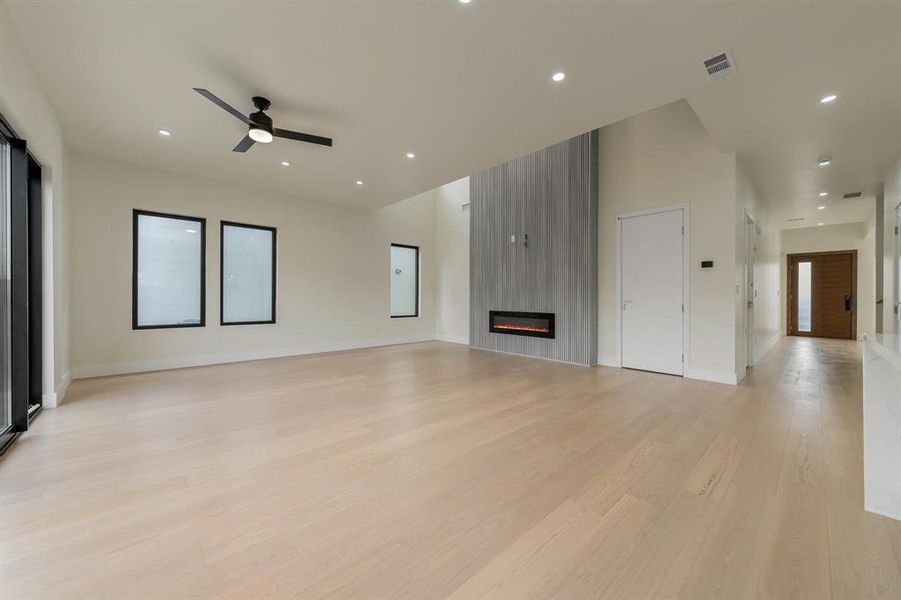 Family room with light wood-style flooring, a fireplace, recessed lighting, and ceiling fan