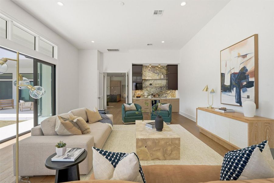 Welcome inside your spectacular first-floor game and family room (one of two game rooms in your home). Sunlight floods this space, highlighting a fully-appointed bar with marble imported from The Vatican. Welcome inside your spectacular first-floor game and family room (one of two game rooms in your home). Sunlight floods this space, highlighting a fully-appointed bar with marble imported from The Vatican.