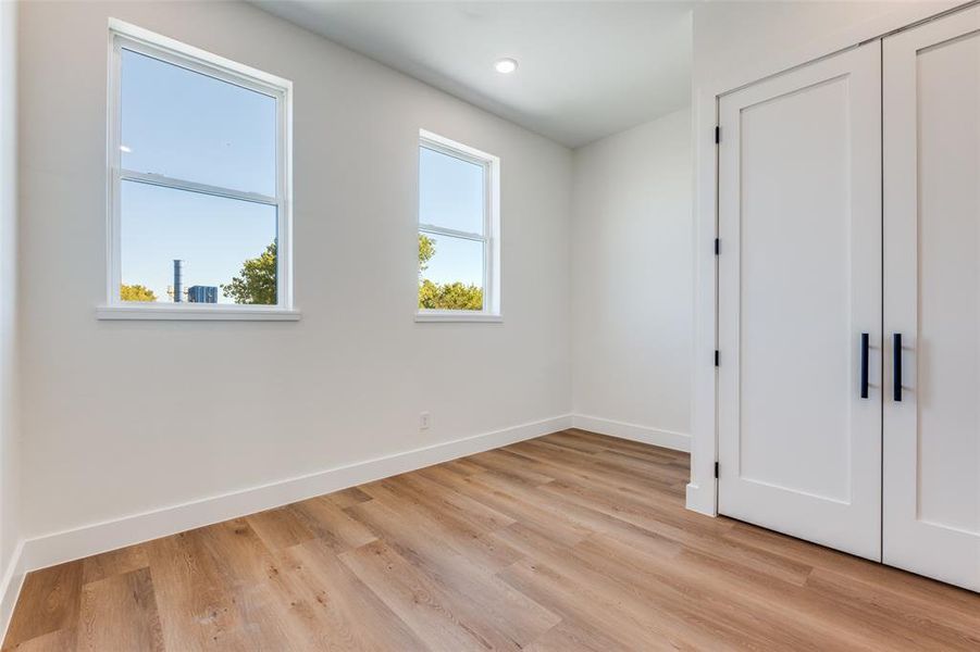 Unfurnished bedroom featuring light wood-style floors, a closet, and recessed lighting