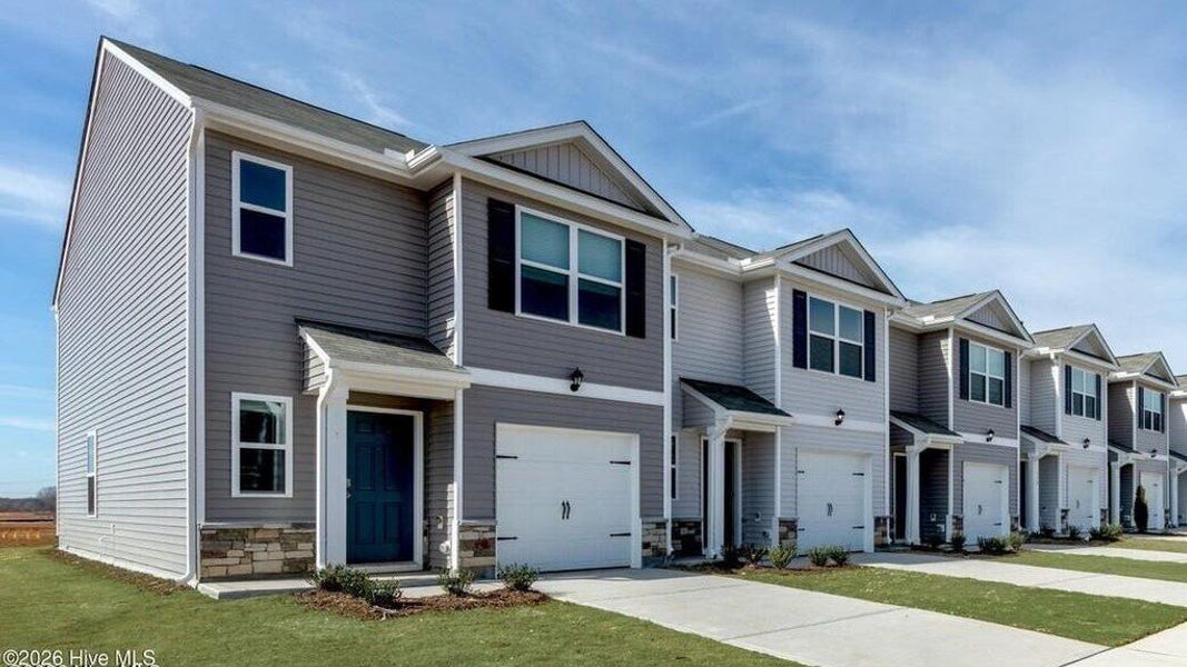 Front exterior of a new home in The Townes at Ridgewood Farms, Winterville, NC, highlighting curb appeal (Image 23).