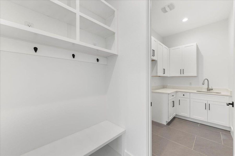 Mudroom featuring dark tile patterned floors and recessed lighting Mudroom featuring dark tile patterned floors and recessed lighting