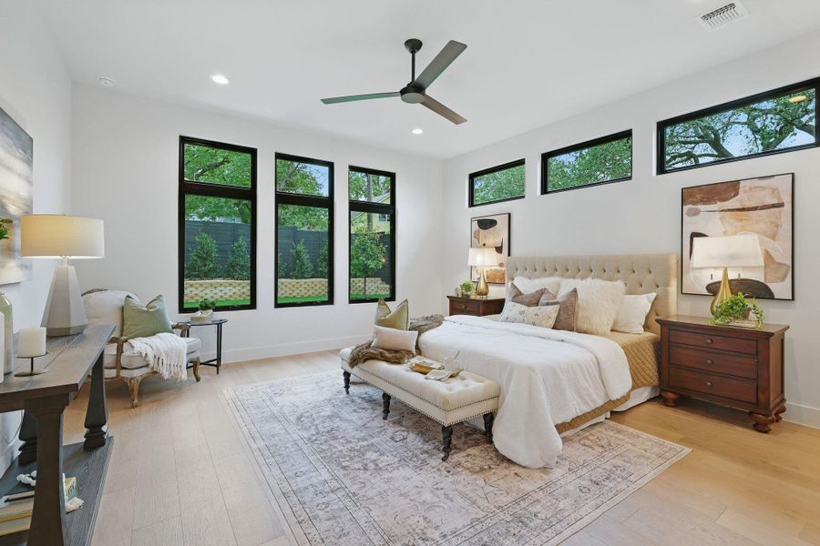 Bedroom with multiple windows, light wood finished floors, recessed lighting, and a ceiling fan