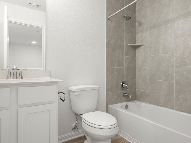 A well-appointed bathroom offers both a shower and tub combination for daily convenience.