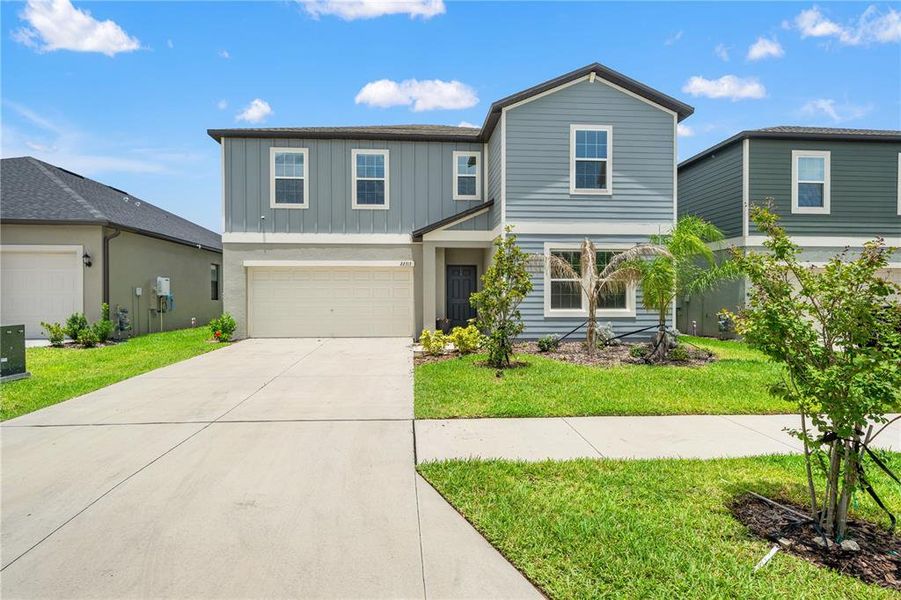 Front exterior of a new home in Connerton, Land O' Lakes, FL, highlighting curb appeal (Image 1). Front exterior of a new home in Connerton, Land O' Lakes, FL, highlighting curb appeal (Image 1).