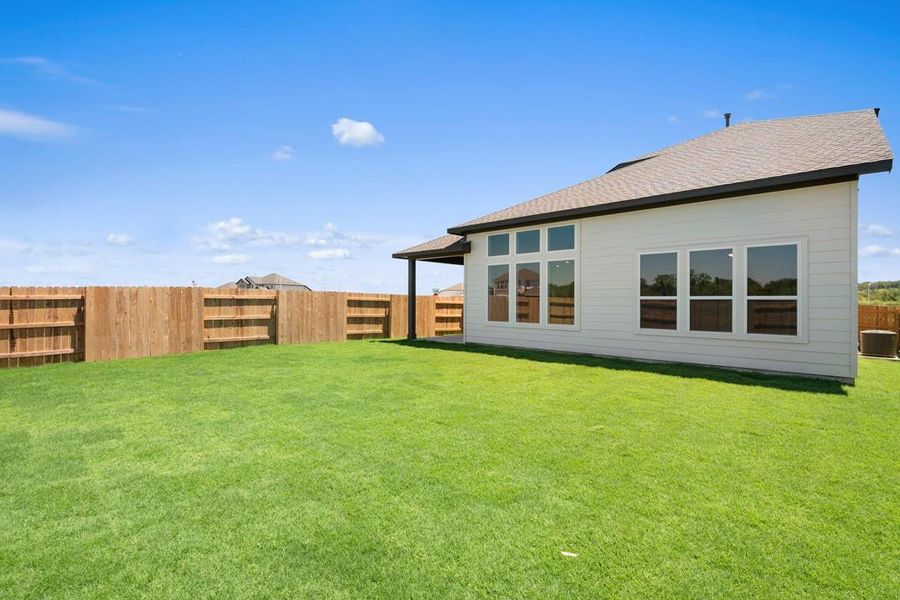 Front exterior of a new home in Lagos Reserve, Manor, TX, highlighting curb appeal (Image 19). Front exterior of a new home in Lagos Reserve, Manor, TX, highlighting curb appeal (Image 19).