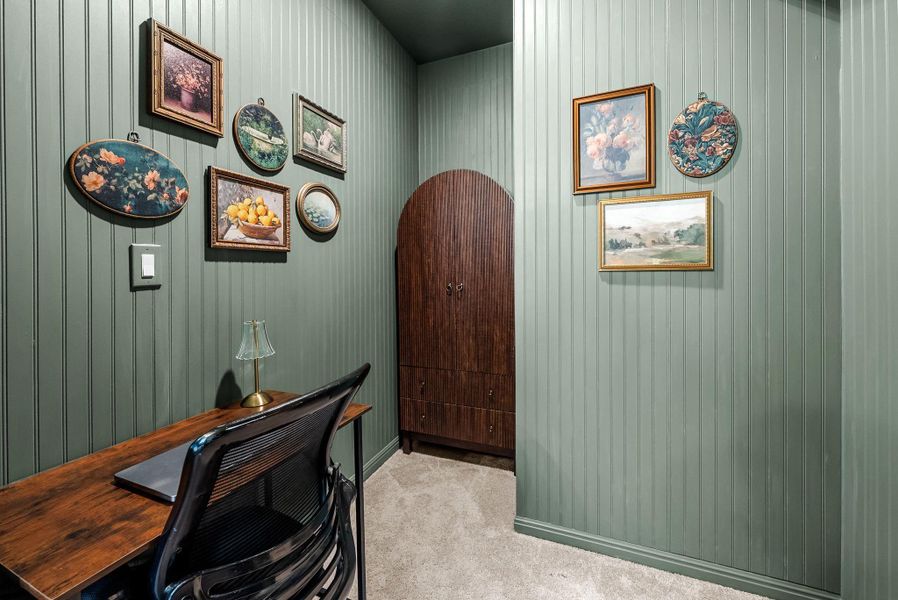 Home office with light colored carpet