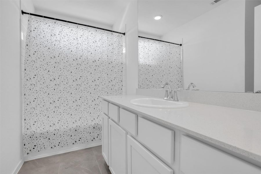 Upstairs Jack-and-Jill Bathroom: Shared full bath serving two bedrooms, with a separate en suite assigned to the third upstairs bedroom. Upstairs Jack-and-Jill Bathroom: Shared full bath serving two bedrooms, with a separate en suite assigned to the third upstairs bedroom.