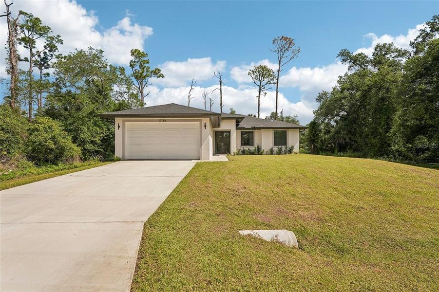Front exterior of a new home in , Port Charlotte, FL, highlighting curb appeal (Image 26).