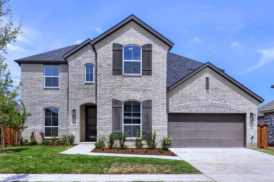 Two-story brick exterior with dark gray roof, arched window accents, dark wood-finish shutters, and an attached two-car garage Two-story brick exterior with dark gray roof, arched window accents, dark wood-finish shutters, and an attached two-car garage