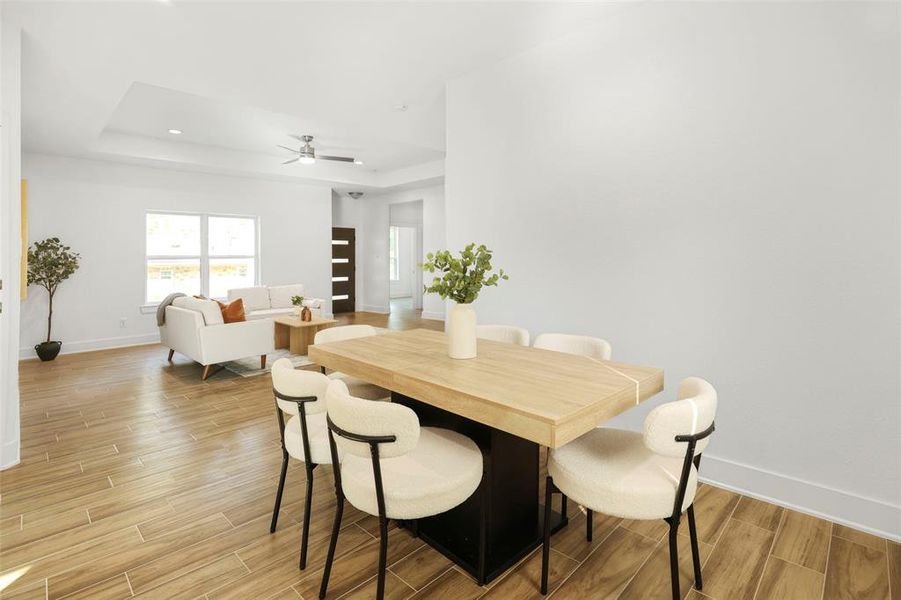 The spacious dining area, seamlessly connected to the kitchen, is perfect for entertaining and family gatherings.