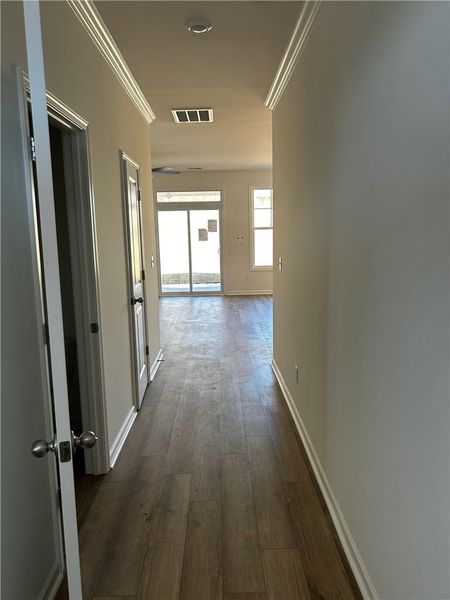 This inviting hallway features elegant crown moldi