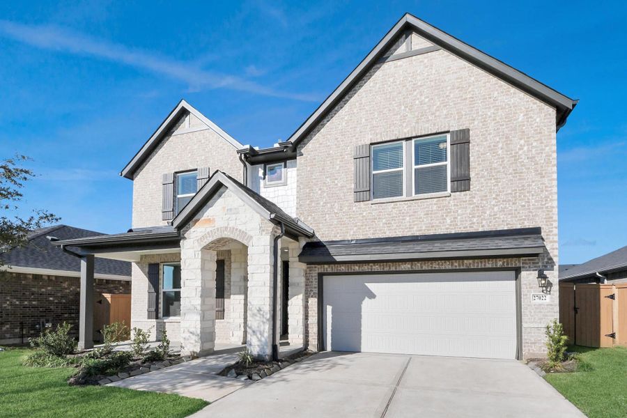 Front exterior of a new home in Sunterra: Landmark Collection, Katy, TX, highlighting curb appeal (Image 24).
