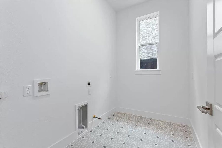 Washroom featuring tile patterned floors, hookup for an electric dryer, washer hookup, and hookup for a gas dryer