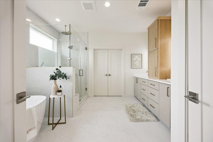 Luxury lives here 24/7. Double doors open from this spa-inspired ensuite to the owner’s retreat, while two customized walk-in closets, a freestanding tub, oversized glass shower and long custom vanity make everyday routines feel a little more indulgent.