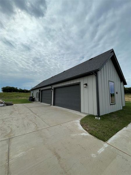 Garage featuring concrete driveway