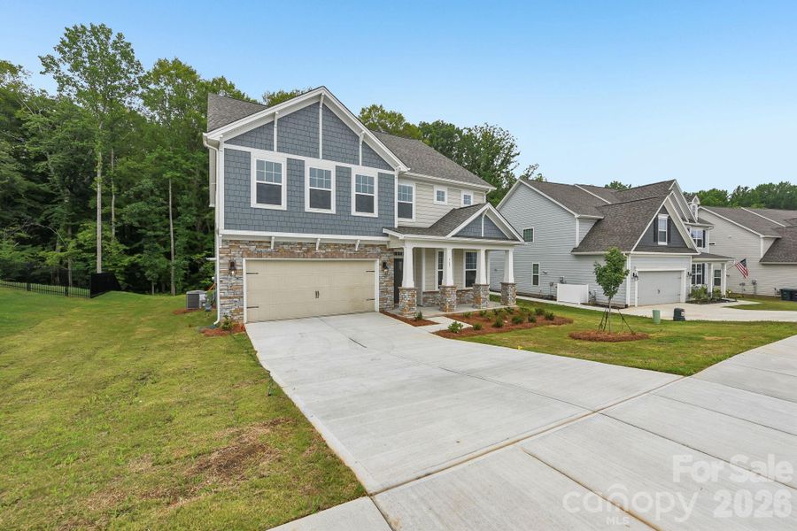 Front exterior of a new home in Falls Cove, Troutman, NC, highlighting curb appeal (Image 17). Front exterior of a new home in Falls Cove, Troutman, NC, highlighting curb appeal (Image 17).