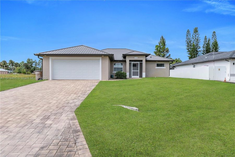 Front exterior of a new home in , Lehigh Acres, FL, highlighting curb appeal (Image 2). Front exterior of a new home in , Lehigh Acres, FL, highlighting curb appeal (Image 2).