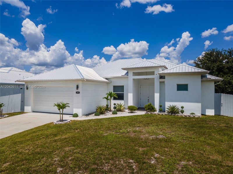 Front exterior of a new home in , Lehigh Acres, FL, highlighting curb appeal (Image 26).