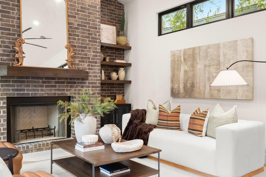 Living area featuring a fireplace and brick wall