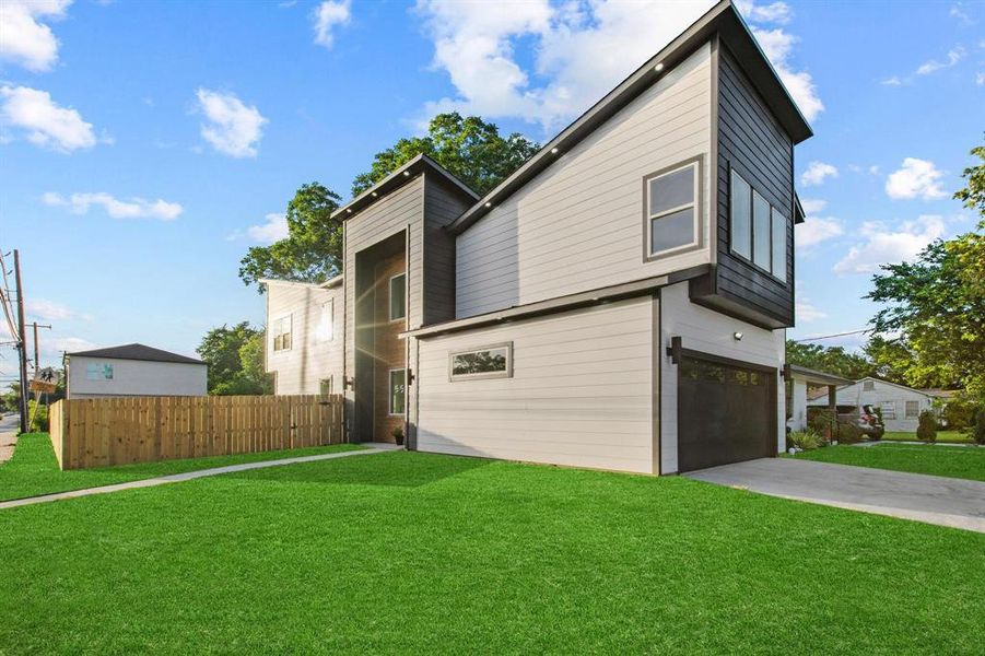 View of front of home featuring concrete driveway and an attached garage