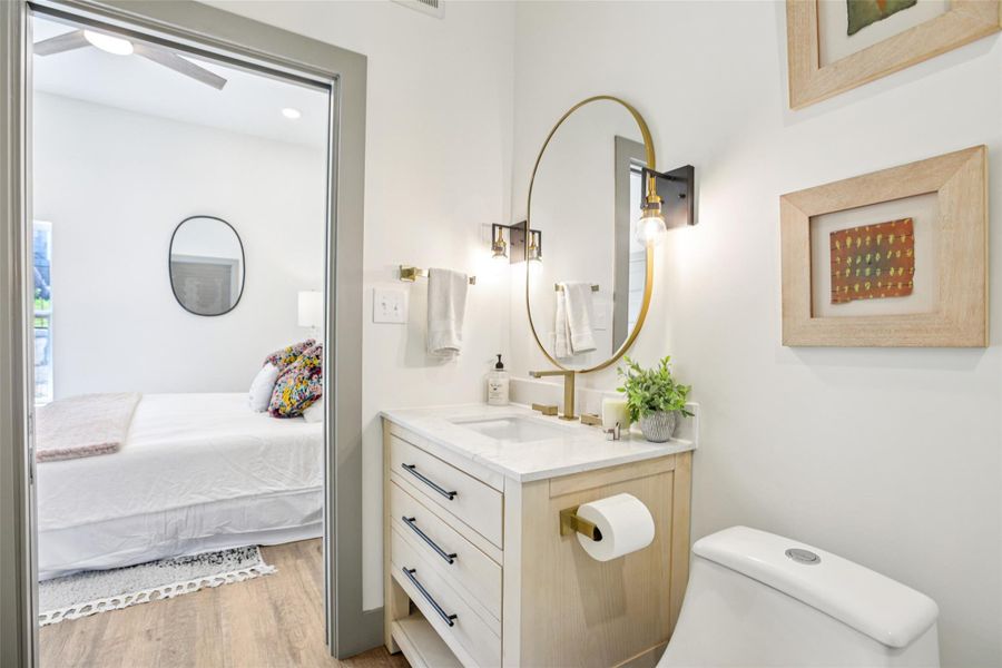 Bathroom featuring vanity, light wood-style flooring, and ensuite bathroom