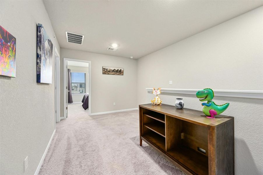 Hallway with light colored carpet