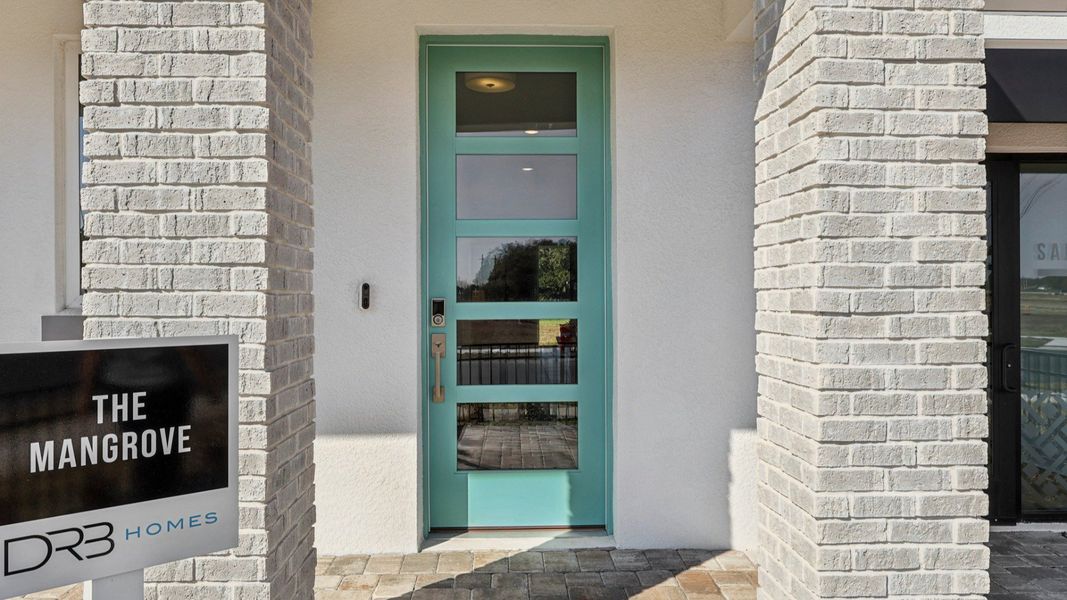 The Mangrove Model Front Porch and Door Entry in a Modern Elevation at Lakeside at Satilla by DRB Homes in Saint Cloud, FL