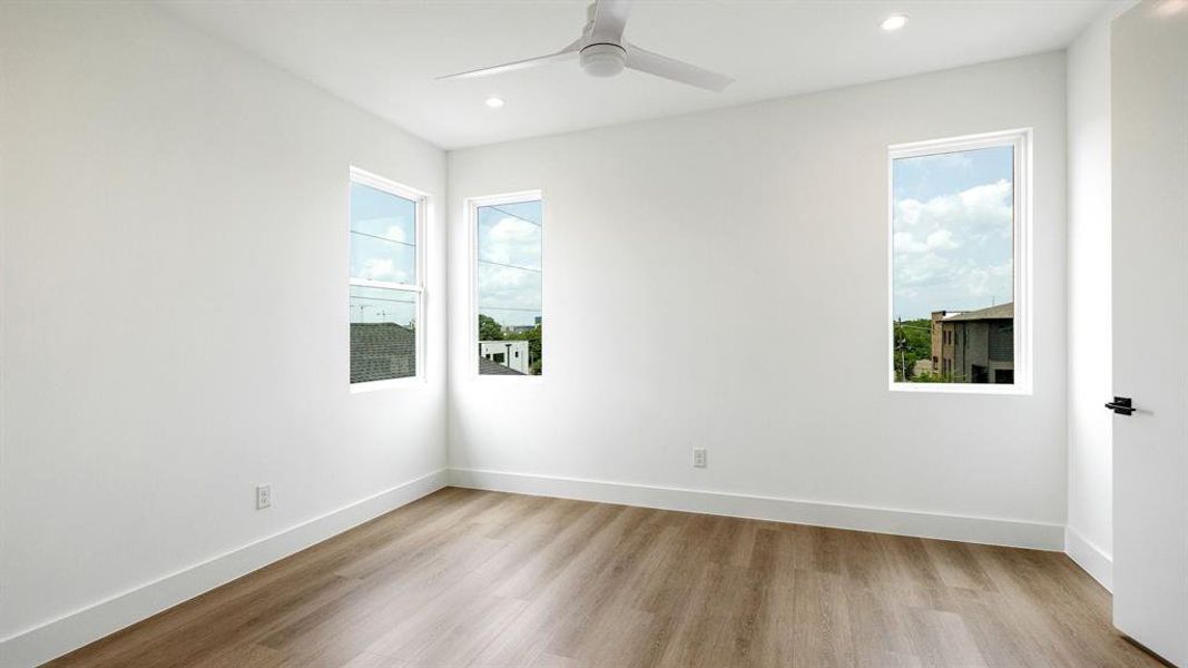 Unfurnished room featuring ceiling fan and light wood-type flooring