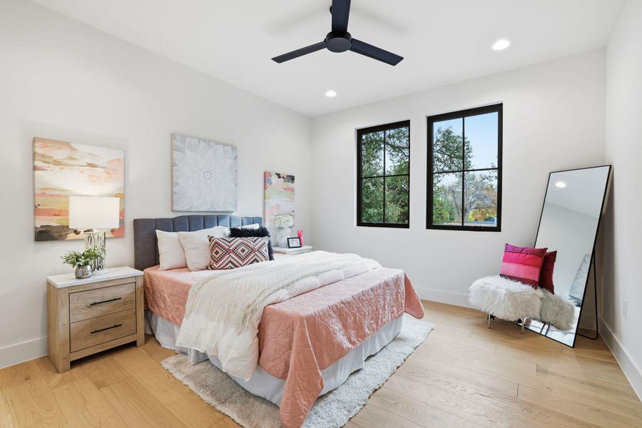Bedroom featuring light wood-type flooring, ceiling fan, and recessed lighting