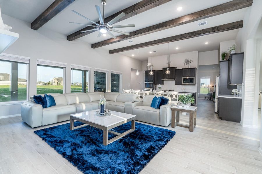 This expansive Greatroom is anchored with the stunning beamed ceiling and gorgeous acreage views.