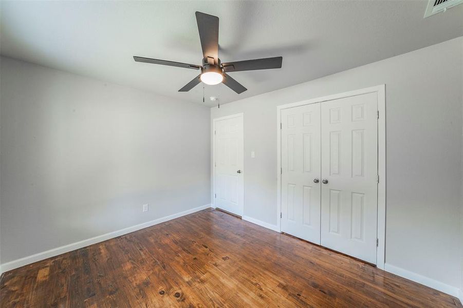 Bedroom with a closet, ceiling fan, and hardwood / wood-style floors